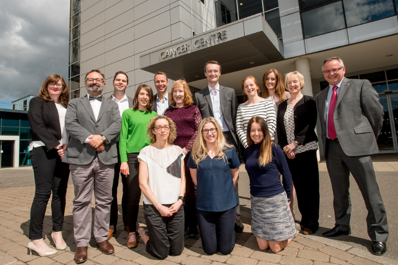 Team of researchers and legator's family outside the Cancer Centre